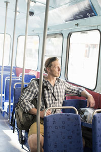 Man sitting on seat in metro train
