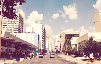 City street and buildings against sky