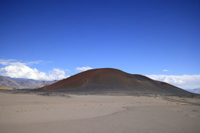 Scenic view of desert against clear blue sky