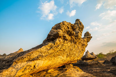 Low angle view of rock formation against sky