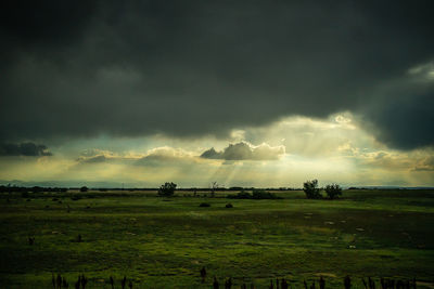 Scenic view of land against cloudy sky
