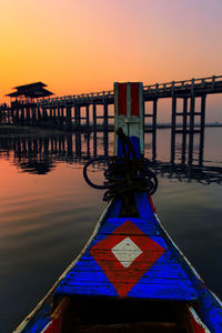 Pier in sea at sunset