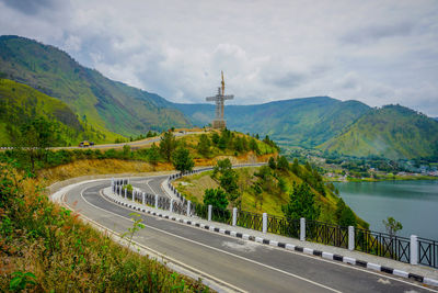 Road by mountain against sky