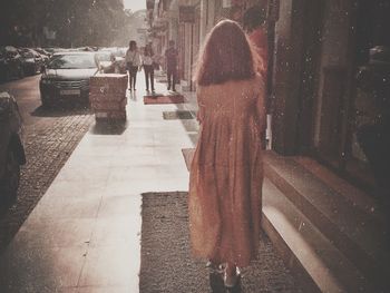 Woman walking on sidewalk