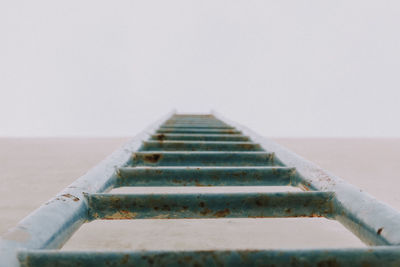 Close-up of ladder against sky