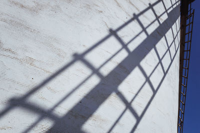 Shadow of fence on wall