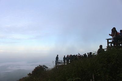 Low angle view of people against sky