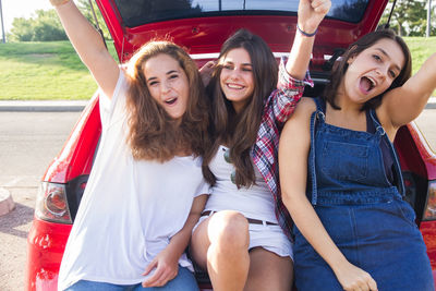 Portrait of happy female friends sitting in car
