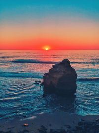 Scenic view of sea against clear sky during sunset