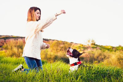 Woman with dog on field