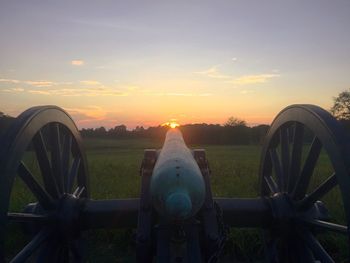 Scenic view of field against sky at sunset