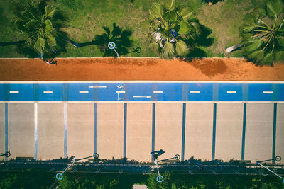 Bike path and walkway on the embankment. top down aerial view of palm trees, walkway and cycle lane