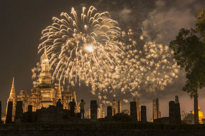 Low angle view of firework display at night