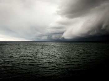 Scenic view of sea against cloudy sky