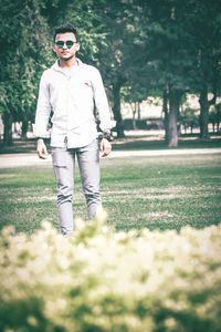 Full length of man wearing sunglasses standing on field