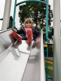 Portrait of girl playing in glass window