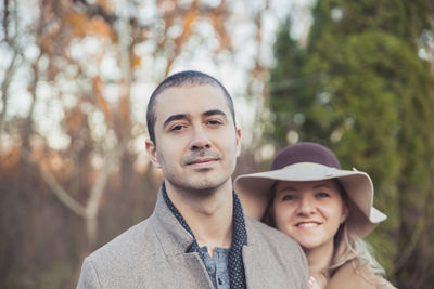 Married couple in coat walking in the autumn park