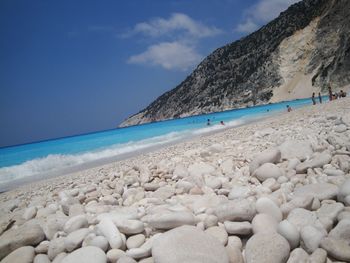 Scenic view of beach against blue sky
