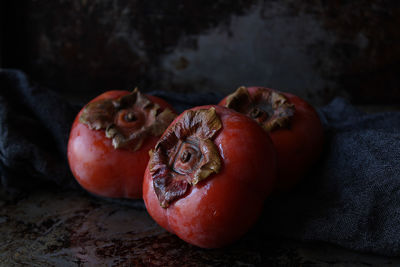 Close-up of wet persimmons on table