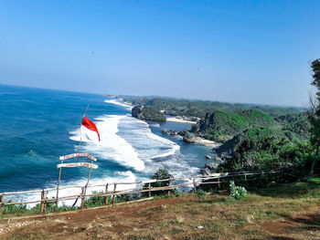 Scenic view of beach against clear blue sky