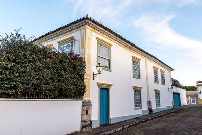 Low angle view of house and building against sky