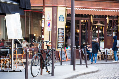 Bicycles on street against buildings in city