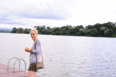 Woman standing in water against sky