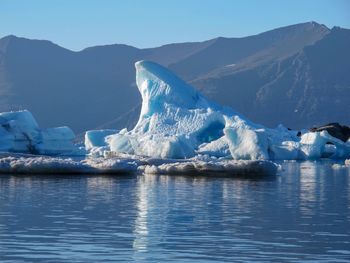 Scenic view of frozen lake against mountain range