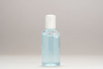 Close-up of glass bottle against white background