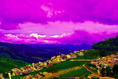 Scenic view of field and mountains against sky