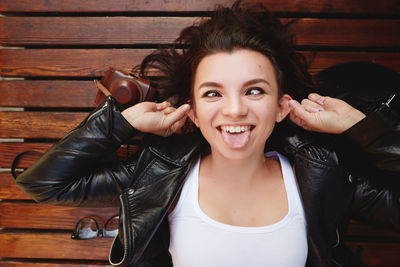 Portrait of young woman sitting on hardwood floor