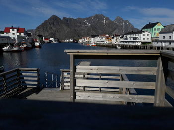 Scenic view of lake by buildings against sky