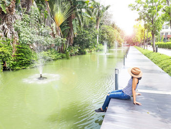 Full length of woman in park by lake