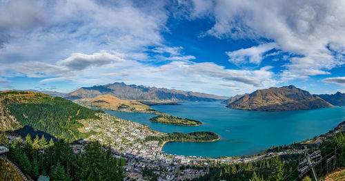 Panoramic view of sea and mountains against sky