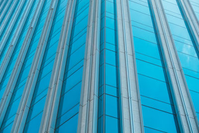 Low angle view of modern building against blue sky