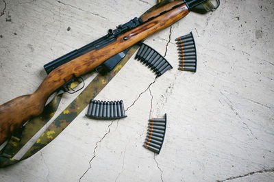 High angle view of rifle on table