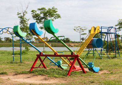 Empty playground in park against sky