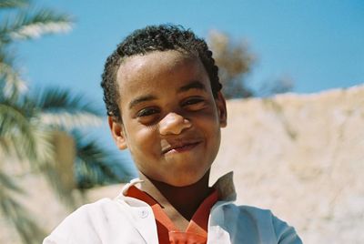 Portrait of smiling boy standing outdoors