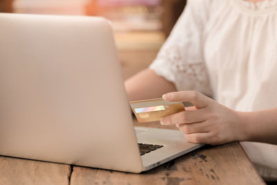 Close-up of woman using mobile phone at home