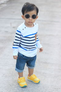 Asian boys wearing black fashion glasses and white striped shirts.