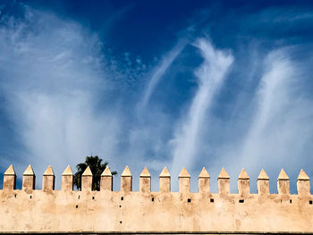 Low angle view of historical building against blue sky