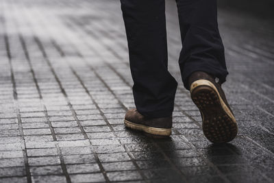 Low section of man standing on footpath