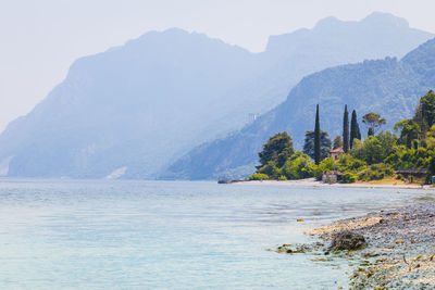 Scenic view of sea and mountains against sky