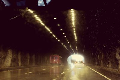 Cars on illuminated road at night