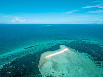 Scenic view of sea against blue sky