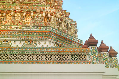 Details of wat arun  temple with mythology figures and pieces of chinese porcelain, bangkok