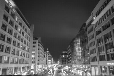 Illuminated city against sky at night