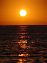 Scenic view of sea against orange sky