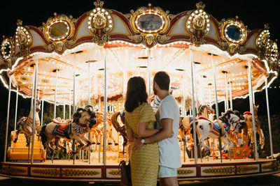 Couple looking at carousel