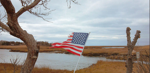 Scenic view of flag against sky